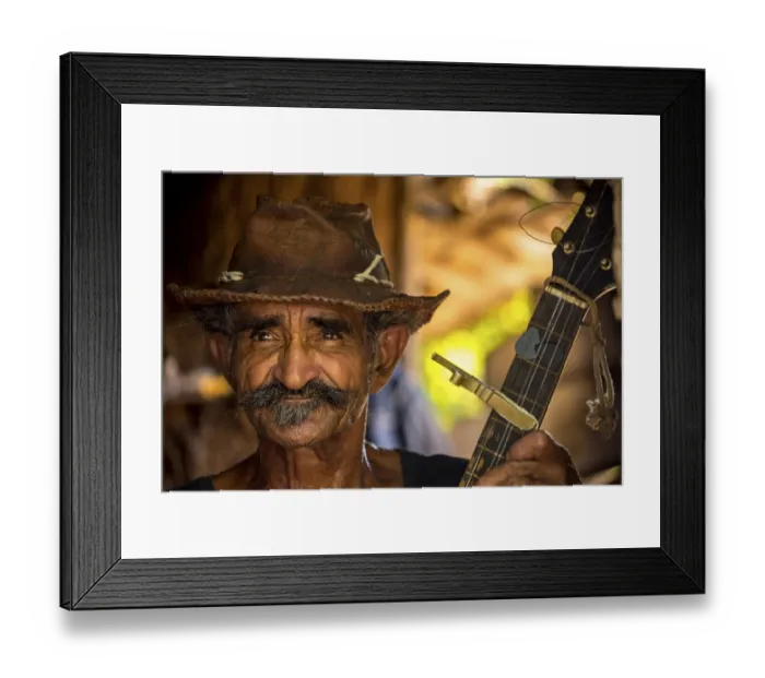 Framed Print : Sugar cane farmer in Valle de los Ingenios plays guitar for the tourists