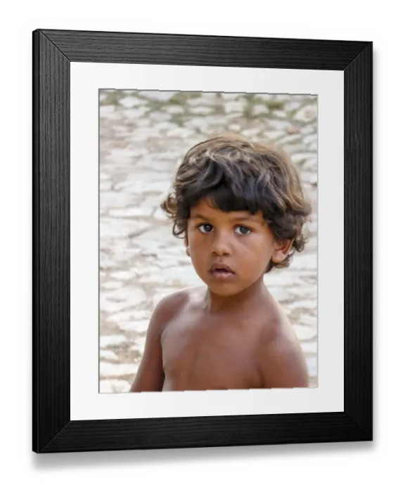 Framed Print : Little Cuban boy on the street in front of an old wall