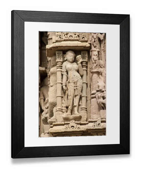 Framed Print : Sculptures on the wall of sun temple at modhera