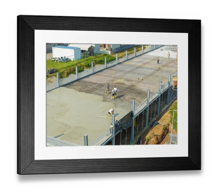 Framed Print : Workers on a construction site smoothing concrete surfaces and using tools Framed Print : Workers on a construction site smoothing concrete surfaces and using tools