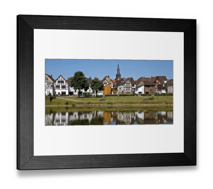 Framed Print : View over the river Weser to the old town centre of Bodenwerder with the church tower of St
