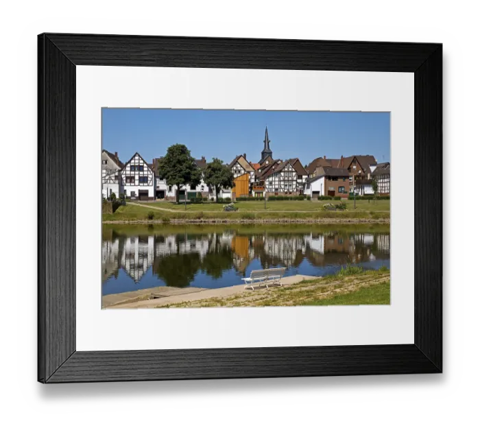 Framed Print : View over the river Weser to the old town centre of Bodenwerder with the church tower of St