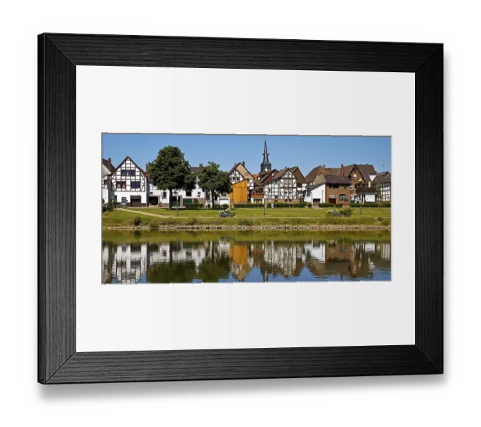 Framed Print : View over the river Weser to the old town centre of Bodenwerder with the church tower of St