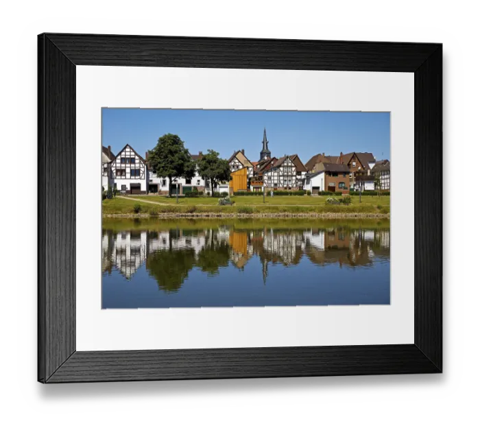 Framed Print : View over the river Weser to the old town centre of Bodenwerder with the church tower of St