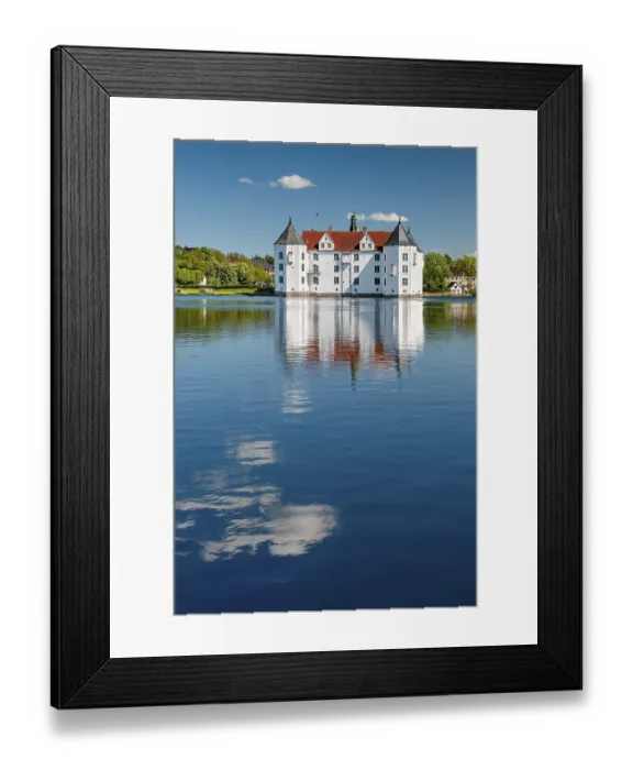 Framed Print : Glucksburg moated castle under a blue sky with white clouds Framed Print : Glucksburg moated castle under a blue sky with white clouds