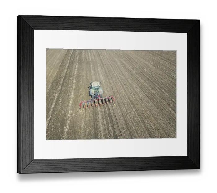 Framed Print : Farmer seeding crops at field. Seeding Aerial View