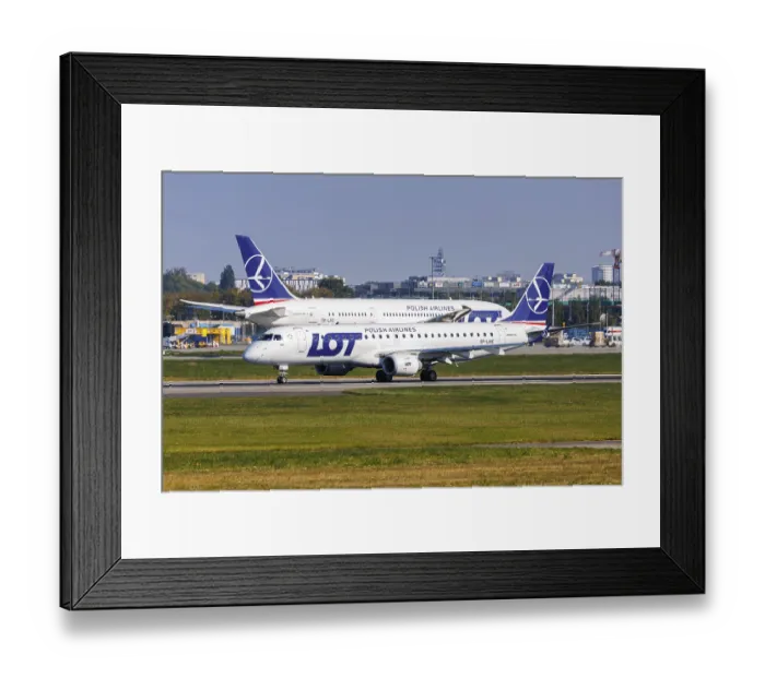 Framed Print : An Embraer 190 aircraft of LOT Polish Airlines with the registration number SP-LME at the airport in Warsaw