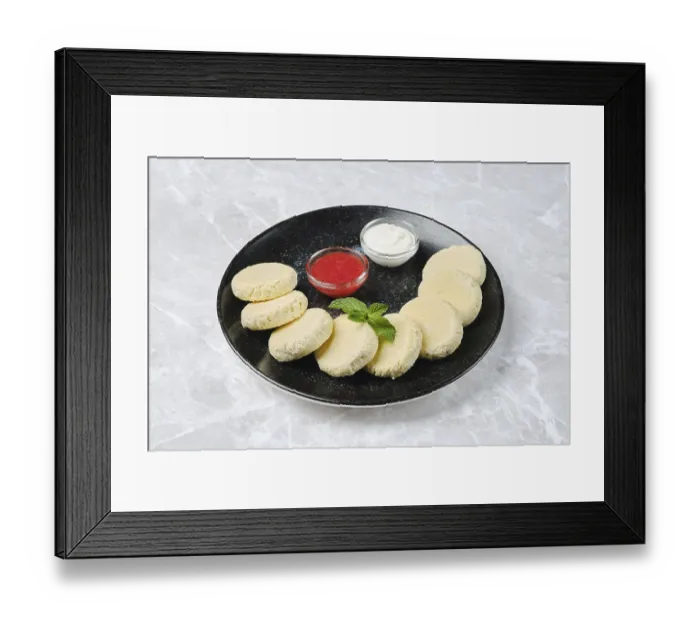Framed Print : A black plate holds soft curd cheese rounds arranged neatly alongside a strawberry jam and a sour cream