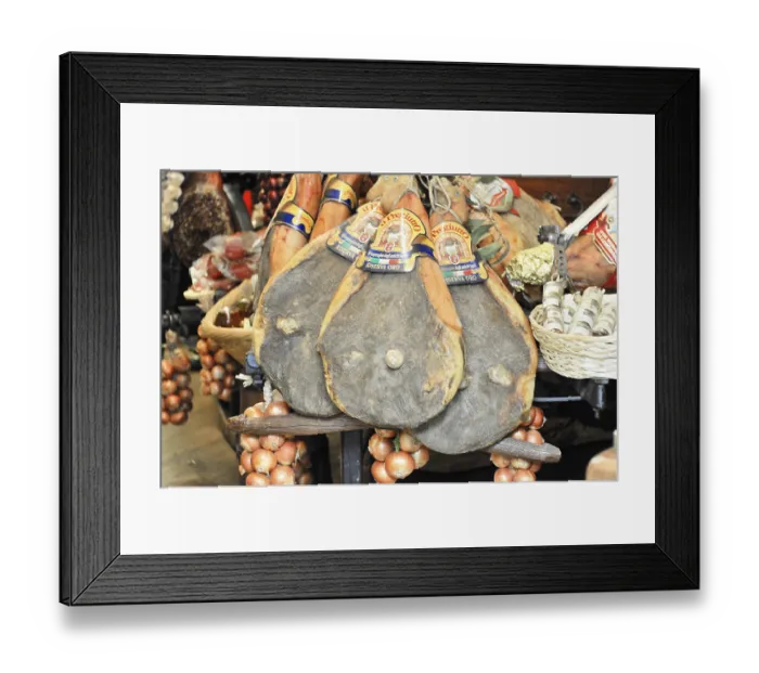 Framed Print : Italian hams and sausages presented in baskets at a market Framed Print : Italian hams and sausages presented in baskets at a market