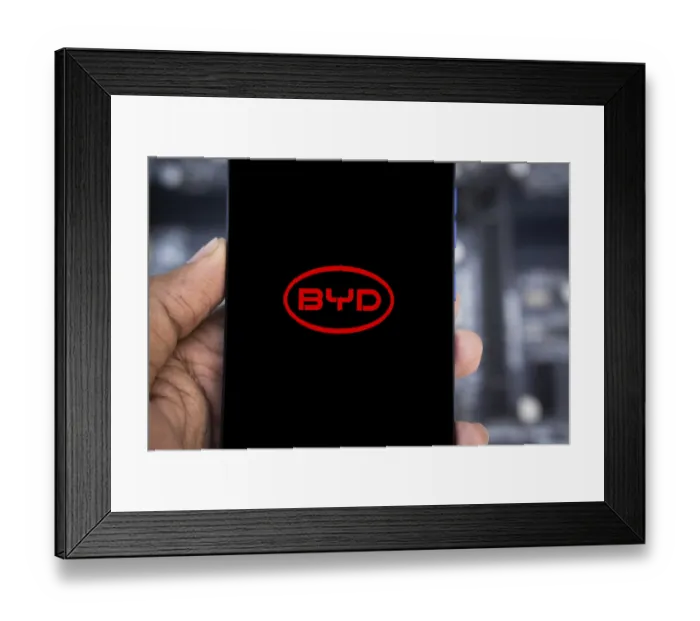 Framed Print : Mobile phone with business logo of Chinese car manufacturer BYD Co