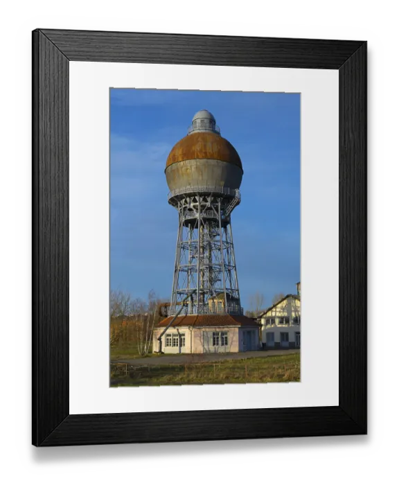 Framed Print : A rusty water tower with industrial construction on a meadow
