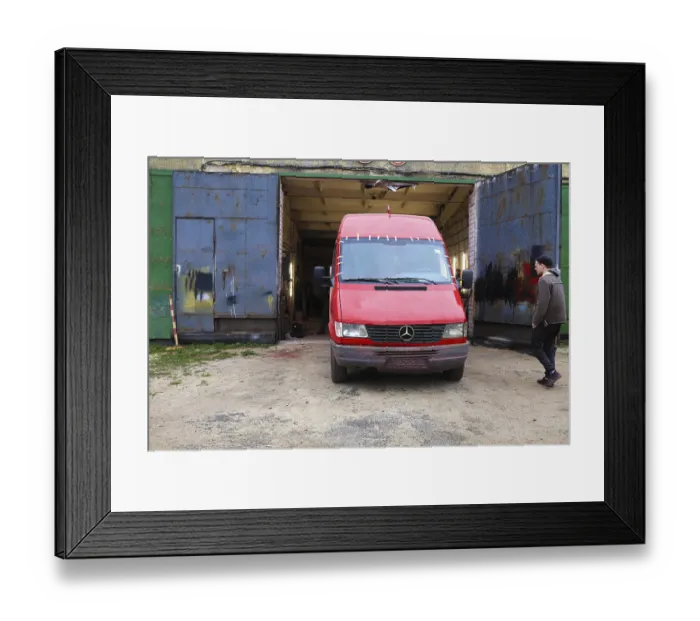 Framed Print : Red Mercedes van in front of a garage with a person nearby