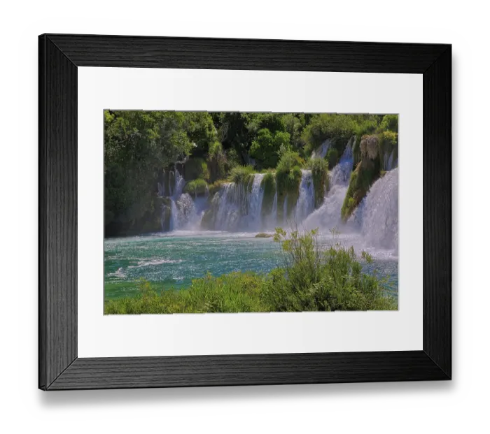 Framed Print : Waterfalls surrounded by dense vegetation and a clear river