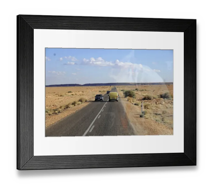 Framed Print : On the road to Erfound, Yellow car and another vehicle on an endless road in the desert