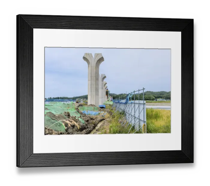 Framed Print : Concrete pillars of new bridge construction standing in a rural landscape under cloudy sky near Hampyeong Framed Print : Concrete pillars of new bridge construction standing in a rural landscape under cloudy sky near Hampyeong