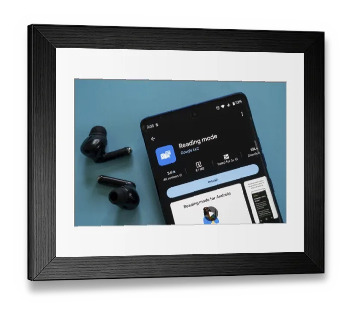 Framed Print : A smartphone showing the Reading mode app by Google ready to install with earbuds beside it Framed Print : A smartphone showing the Reading mode app by Google ready to install with earbuds beside it