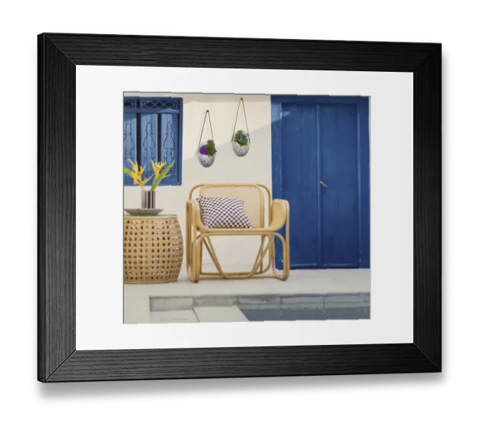 Framed Print : Rattan chair by a poolside with blue door and window