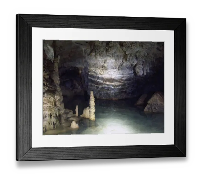 Framed Print : Hand lamp lit underground lake inside stalactite cave with stalactites and stalagmites stalactite formations