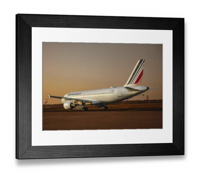 Framed Print : An Air France aircraft on the runway at sunset