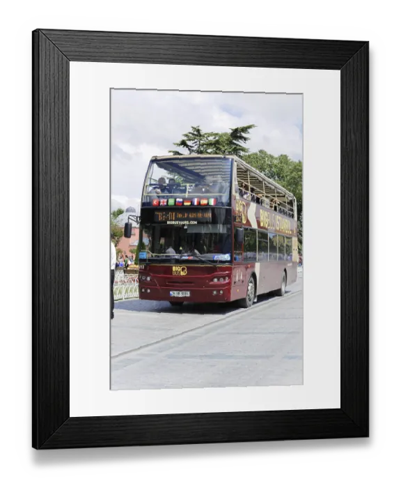 Framed Print : Large double-decker bus drives tourists through the streets
