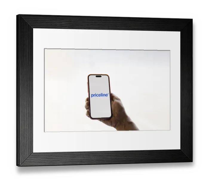 Framed Print : priceline logo is displayed on smartphone