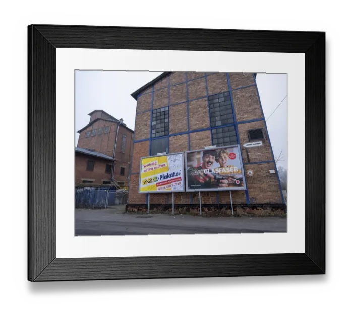 Framed Print : Large posters with advertising for billboards and fibre optics from Vodafone on the wall of an industrial building