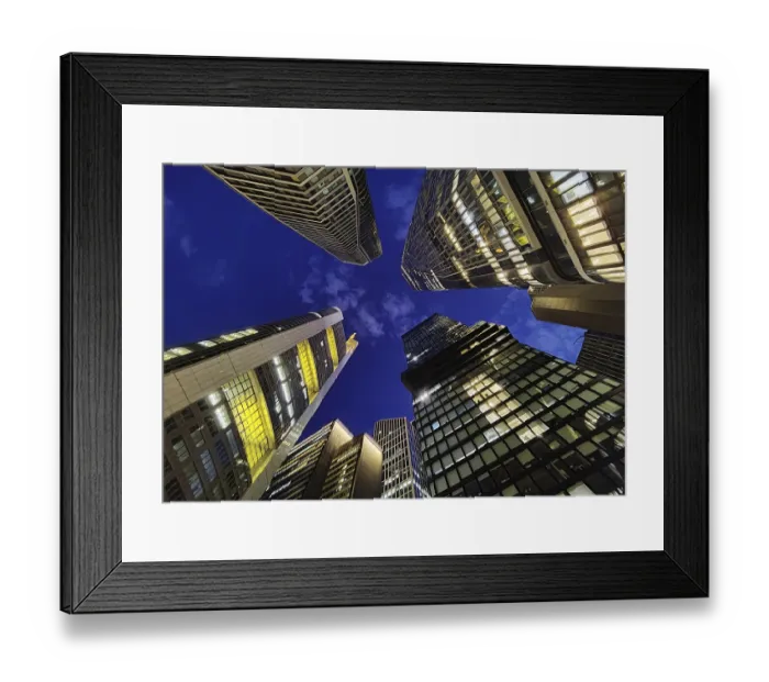Framed Print : Frog's-eye view of skyscrapers in the banking district in the evening