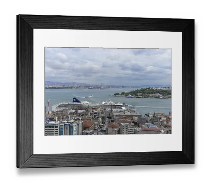 Framed Print : Cruise ship at the harbour with city view and cloudy horizon