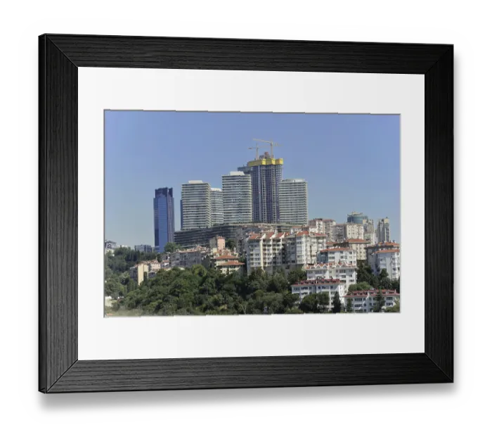 Framed Print : High-rise buildings under construction surrounded by residential buildings in a green urban landscape