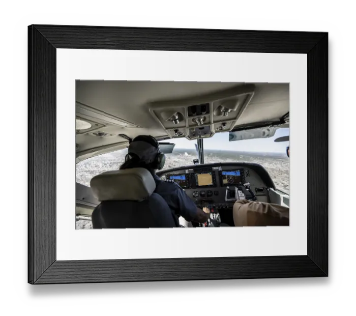 Framed Print : Cockpit Cesna Caravan with pilot on approach to Airstrip