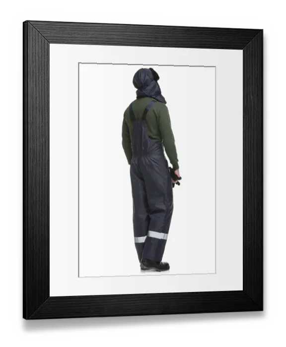 Framed Print : Man in blue work overalls and winter cap isolated full-length rearview