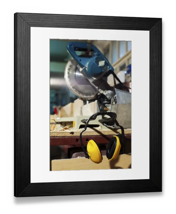 Framed Print : Wood circular saw and protective earphones at plywood manufactory