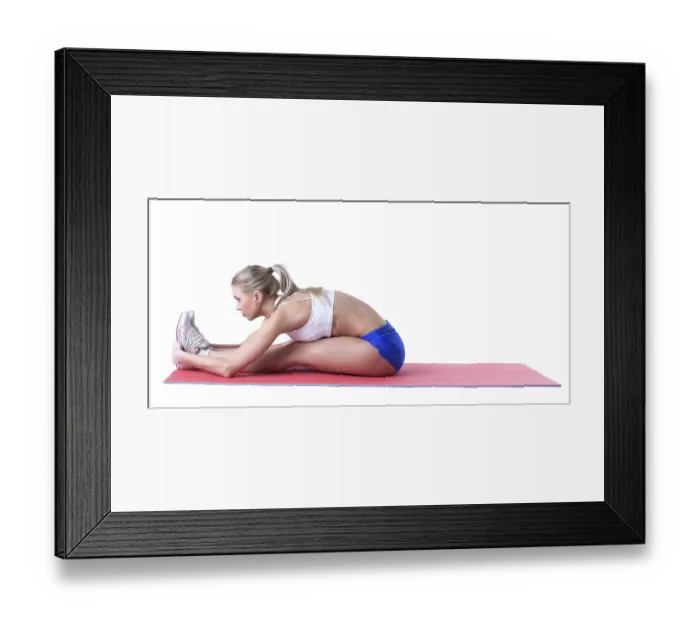 Framed Print : Attractive sporty girl doing exercises on mat in studio