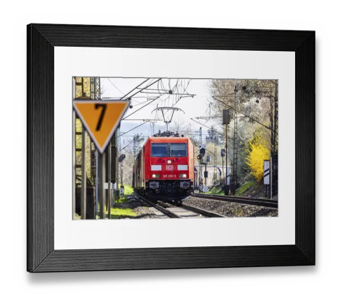 Framed Print : Goods train with a Deutsche Bahn AG locomotive travelling on the open track Framed Print : Goods train with a Deutsche Bahn AG locomotive travelling on the open track