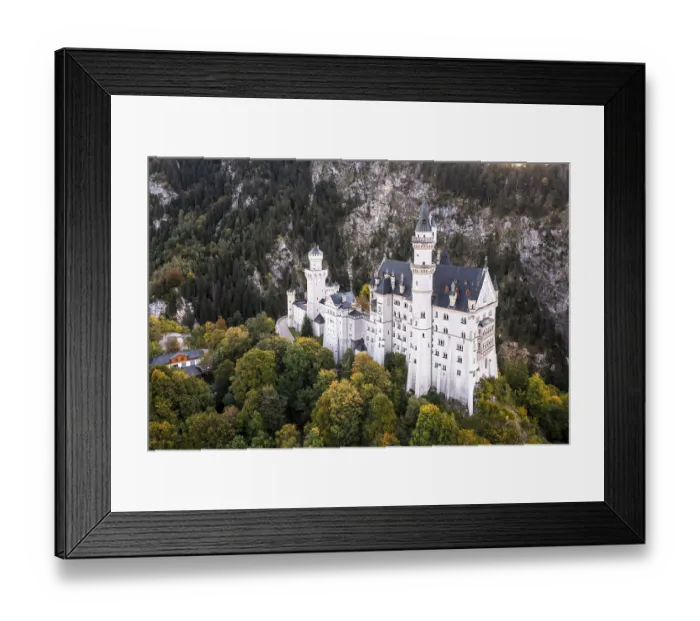 Framed Print : An imposing castle surrounded by dense forests in the mountains