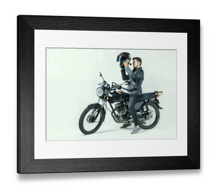 Framed Print : Man on motorcycle putting on helmet Framed Print : Man on motorcycle putting on helmet