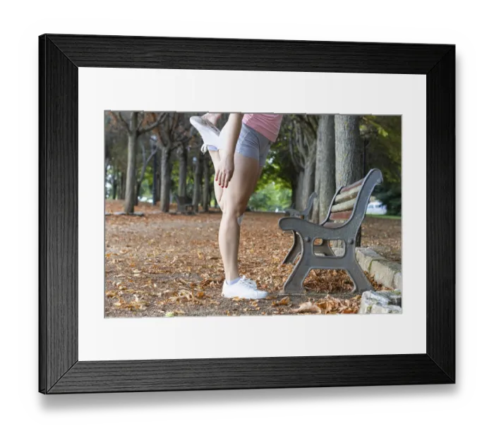 Framed Print : Attractive sporty woman warming up in a park Framed Print : Attractive sporty woman warming up in a park