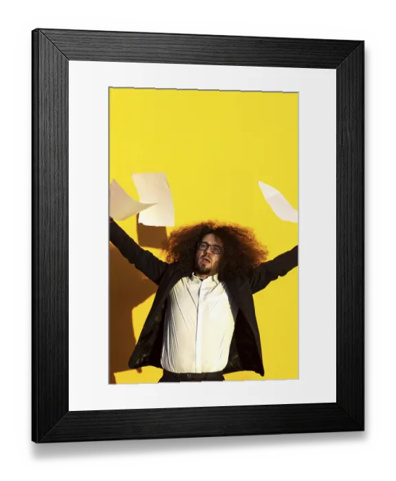 Framed Print : Business man throwing documents in the air on isolated background Framed Print : Business man throwing documents in the air on isolated background