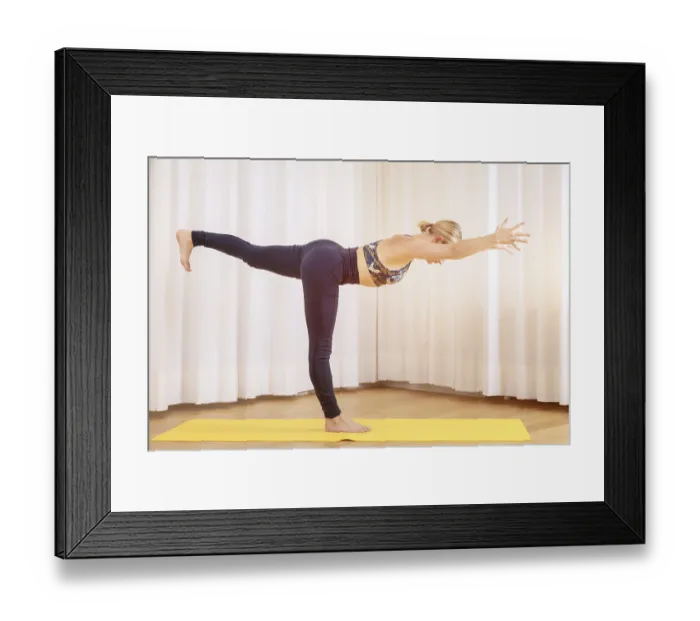Framed Print : An image of a young woman doing yoga standing position