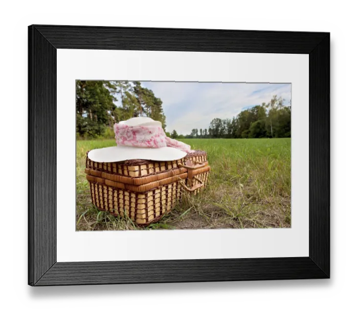 Framed Print : Picnic basket with straw hat, on green grass