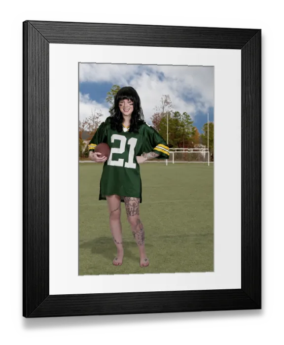Framed Print : Beautiful young woman playing a game of football