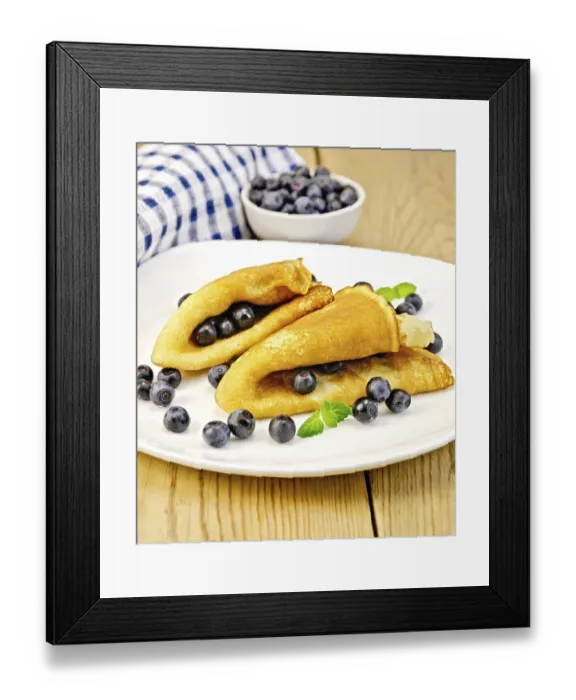 Framed Print : Two pancakes with blueberries and mint on a white plate