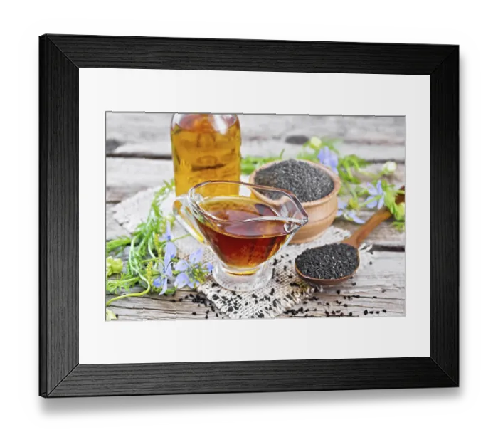 Framed Print : Nigella sativa oil in sauceboat and bottle
