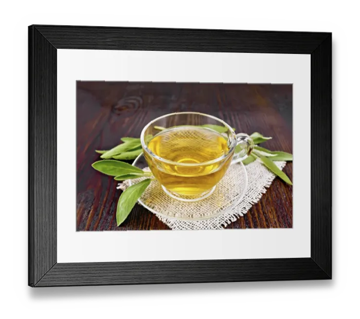 Framed Print : Herbal tea with sage in a glass cup on a burlap napkin on a wooden board background