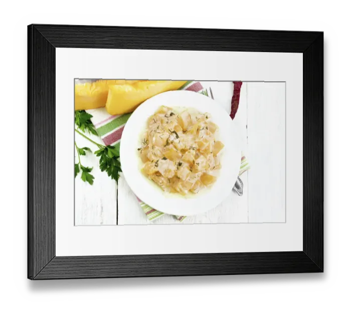 Framed Print : Fried pumpkin with garlic, spices and herbs in sour cream sauce in a plate on a towel