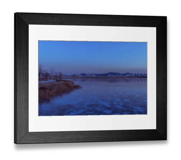 Framed Print : Serene dawn with a waterfront city skyline and ice in the foreground Framed Print : Serene dawn with a waterfront city skyline and ice in the foreground