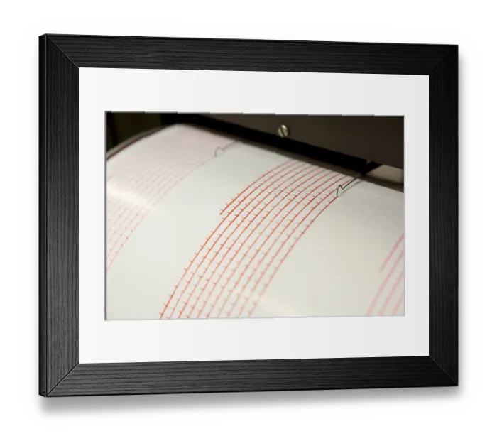 Framed Print : Seismograph records an earthquake on the sheet of measuring paper