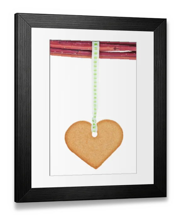 Framed Print : Homemade gingerbread heart hanging from branches isolated over white background