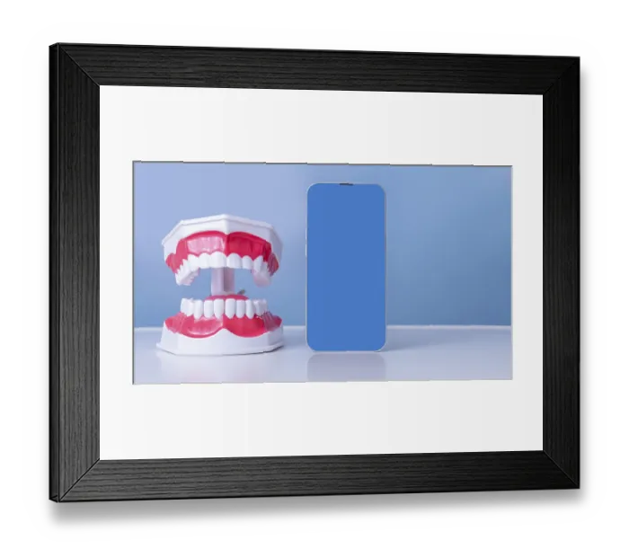 Framed Print : Dental model with smartphone display on blue background Framed Print : Dental model with smartphone display on blue background