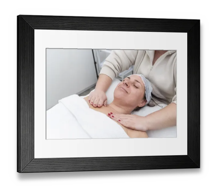 Framed Print : Beautician massaging female client's chest